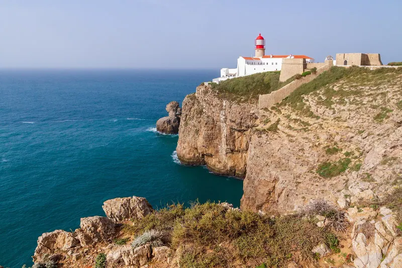 Cabo de Sao Vicente lighthouse and fortress on high sea cliffs above deep blue water