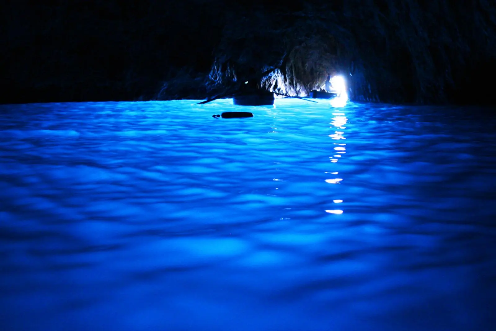 Glowing blue water inside the Blue Grotto on Capri