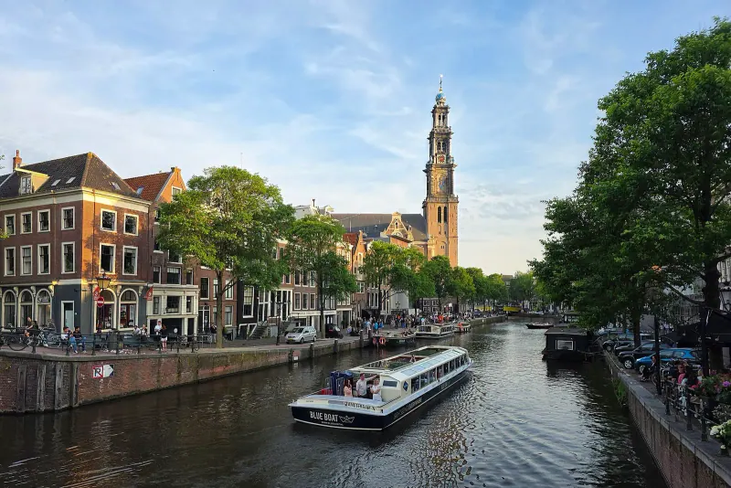 A glass-roofed canal boat on an Amsterdam canal