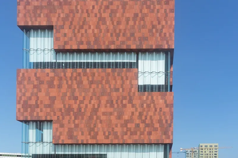 The stacked red facade of the MAS museum in Antwerp