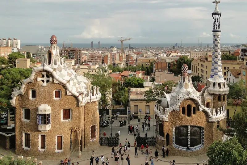 The gatehouses of Park Güell with Barcelona behind