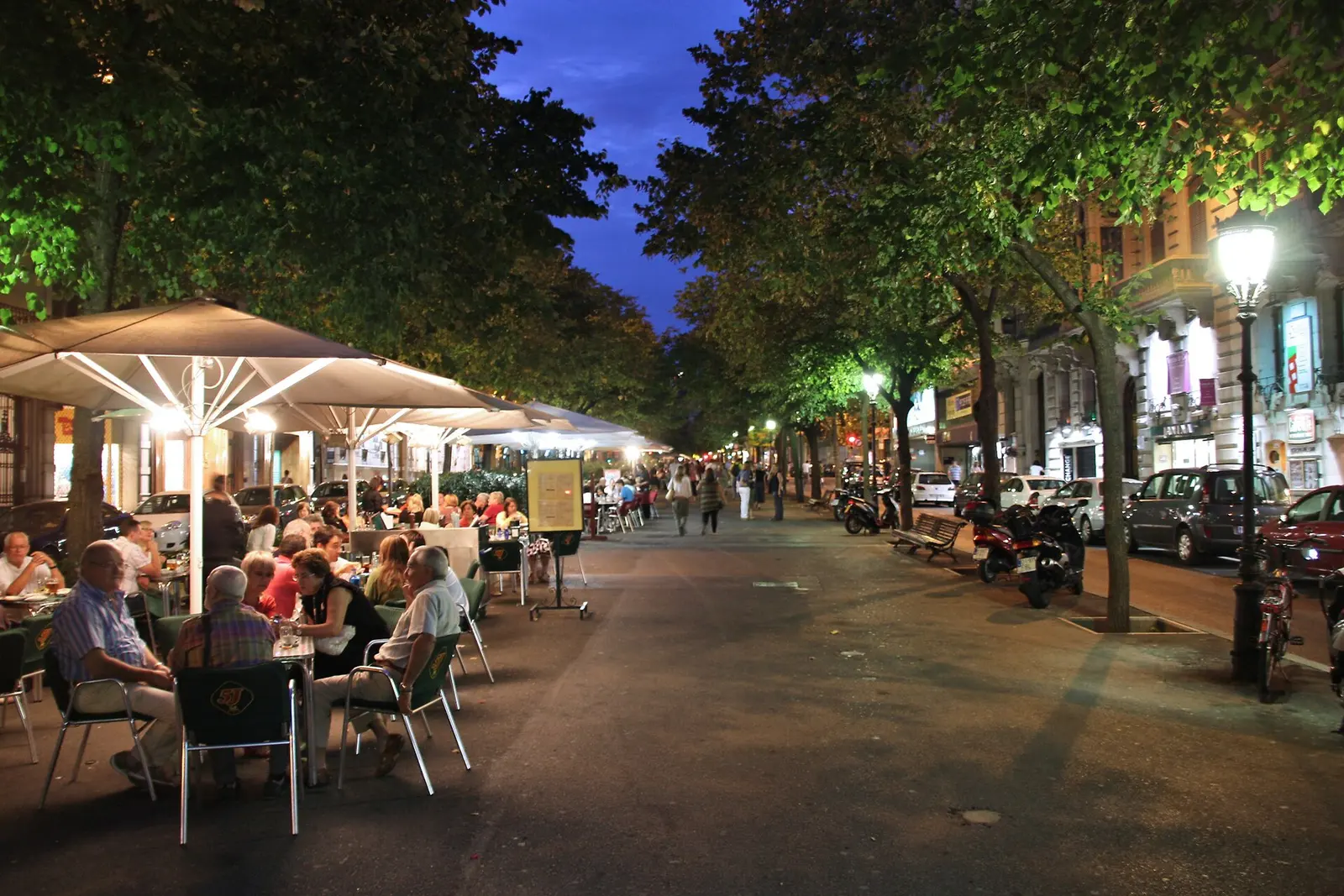 Café tables along the Rambla de Catalunya in the Eixample at night
