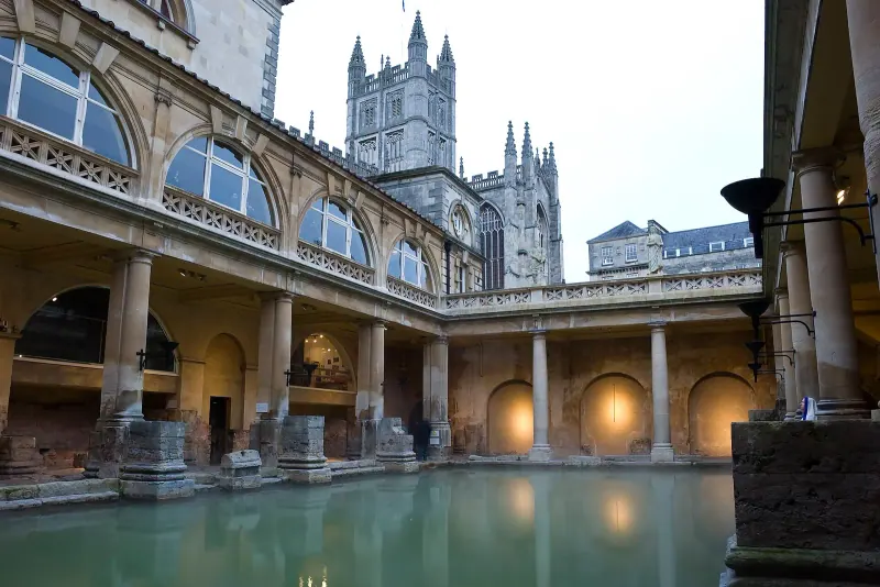 The Great Bath in Bath with Bath Abbey rising behind the colonnade