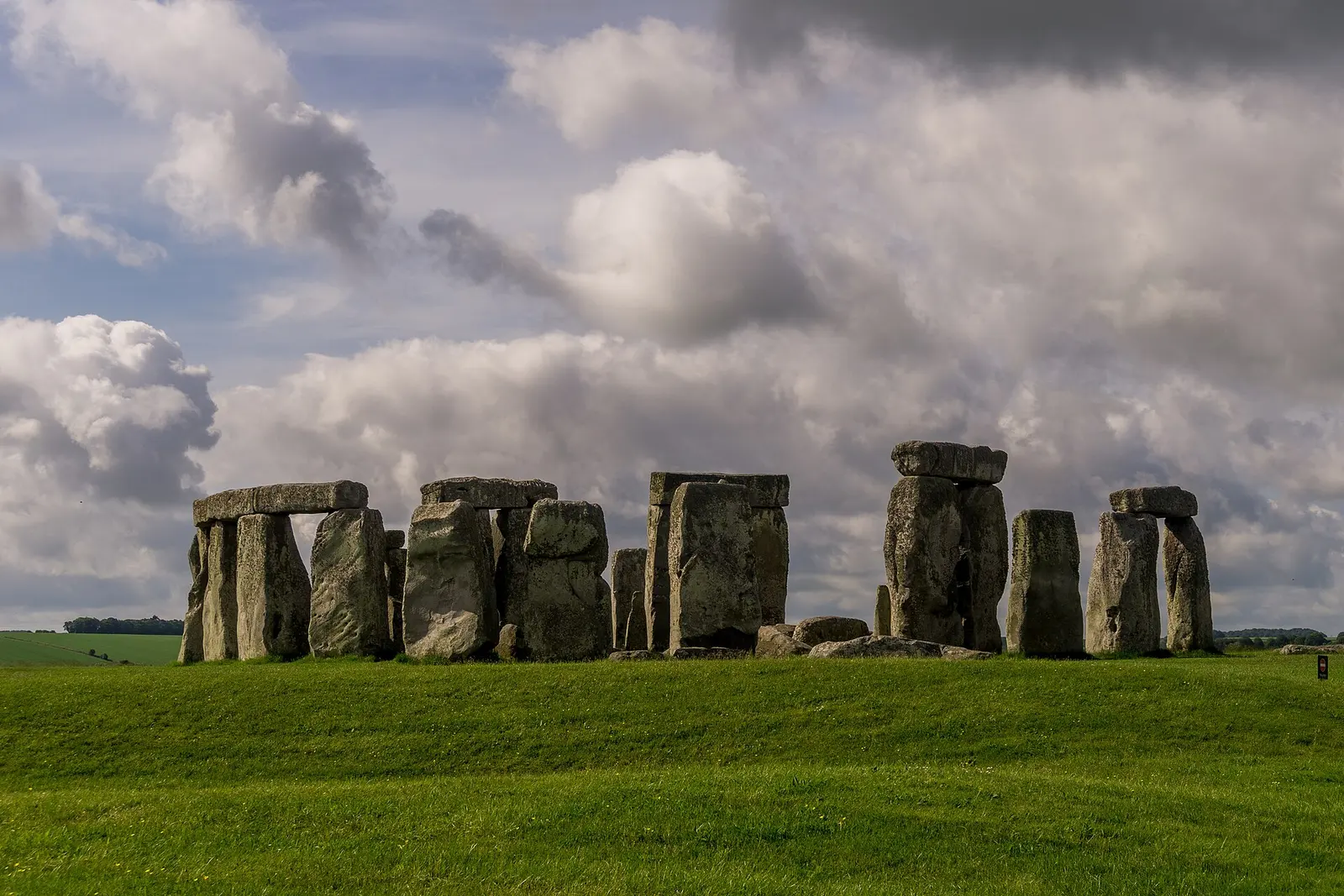 The stone circle of Stonehenge under a cloudy Wiltshire sky