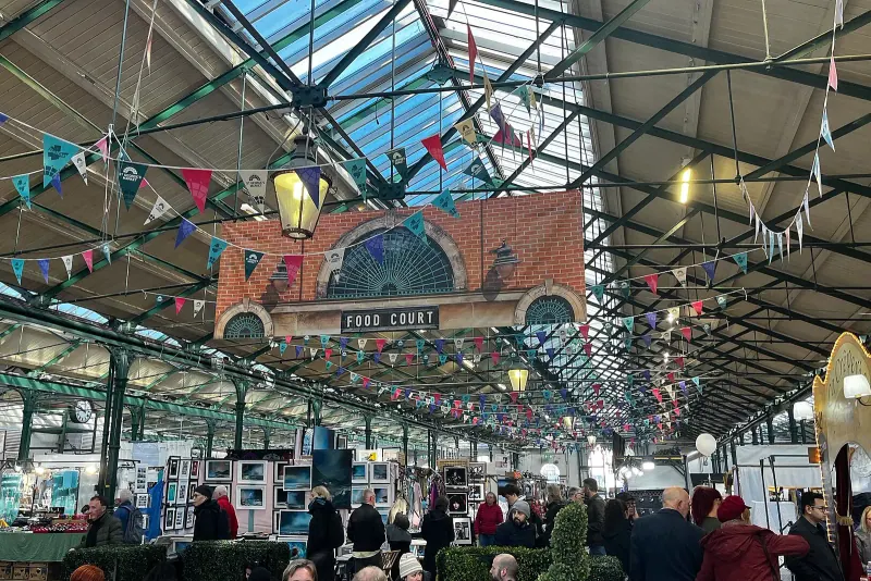 Food stalls and shoppers inside the St George's Market food court