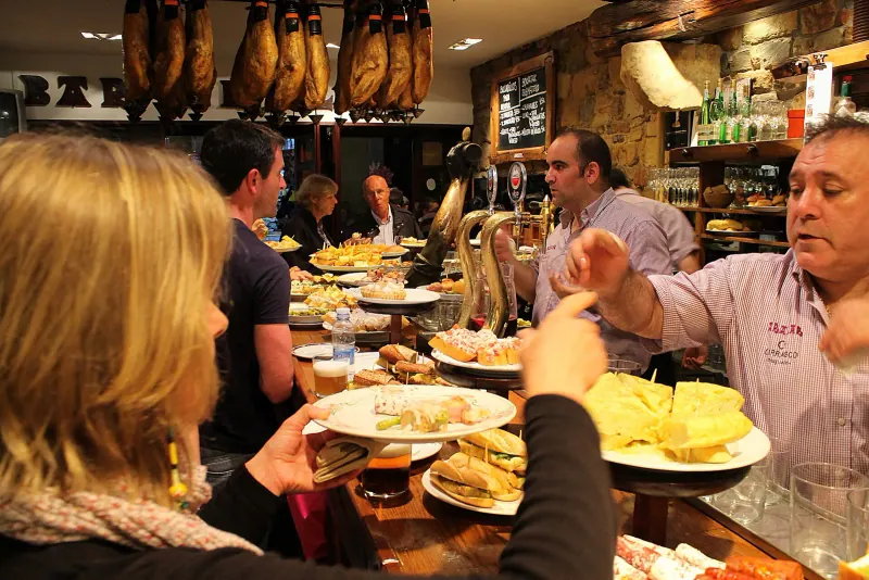 Pintxos being served at a bar counter in Bilbao