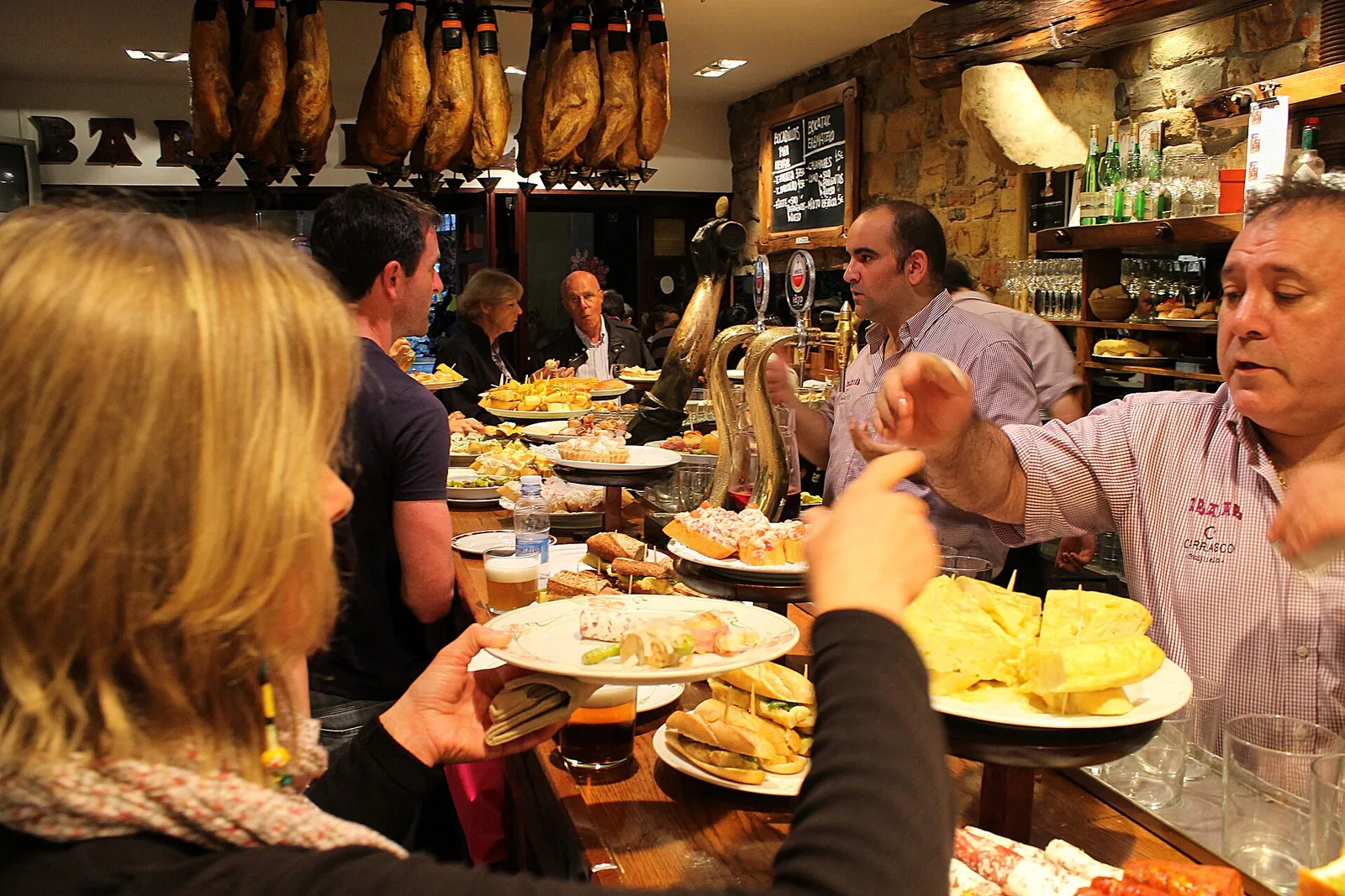 Pintxos being served at a bar counter in Bilbao