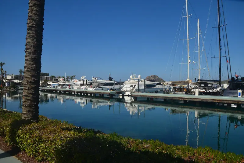 Calm Yalikavak marina with yachts moored along a pontoon under a clear blue sky