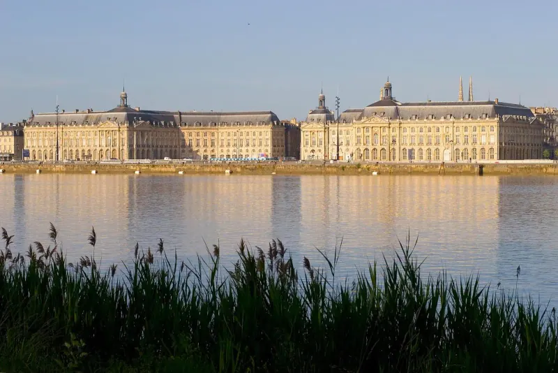 Place de la Bourse reflecting on the Garonne riverfront at dusk in Bordeaux