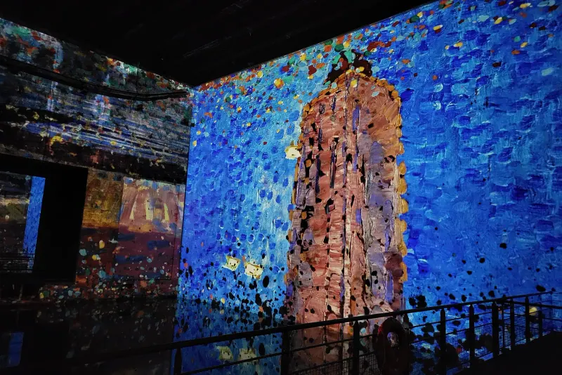 Classical artworks projected across the walls and water inside Bassins des Lumieres