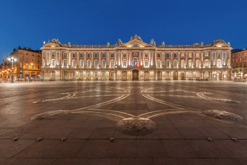 The Capitole square and its lit facade at night in Toulouse