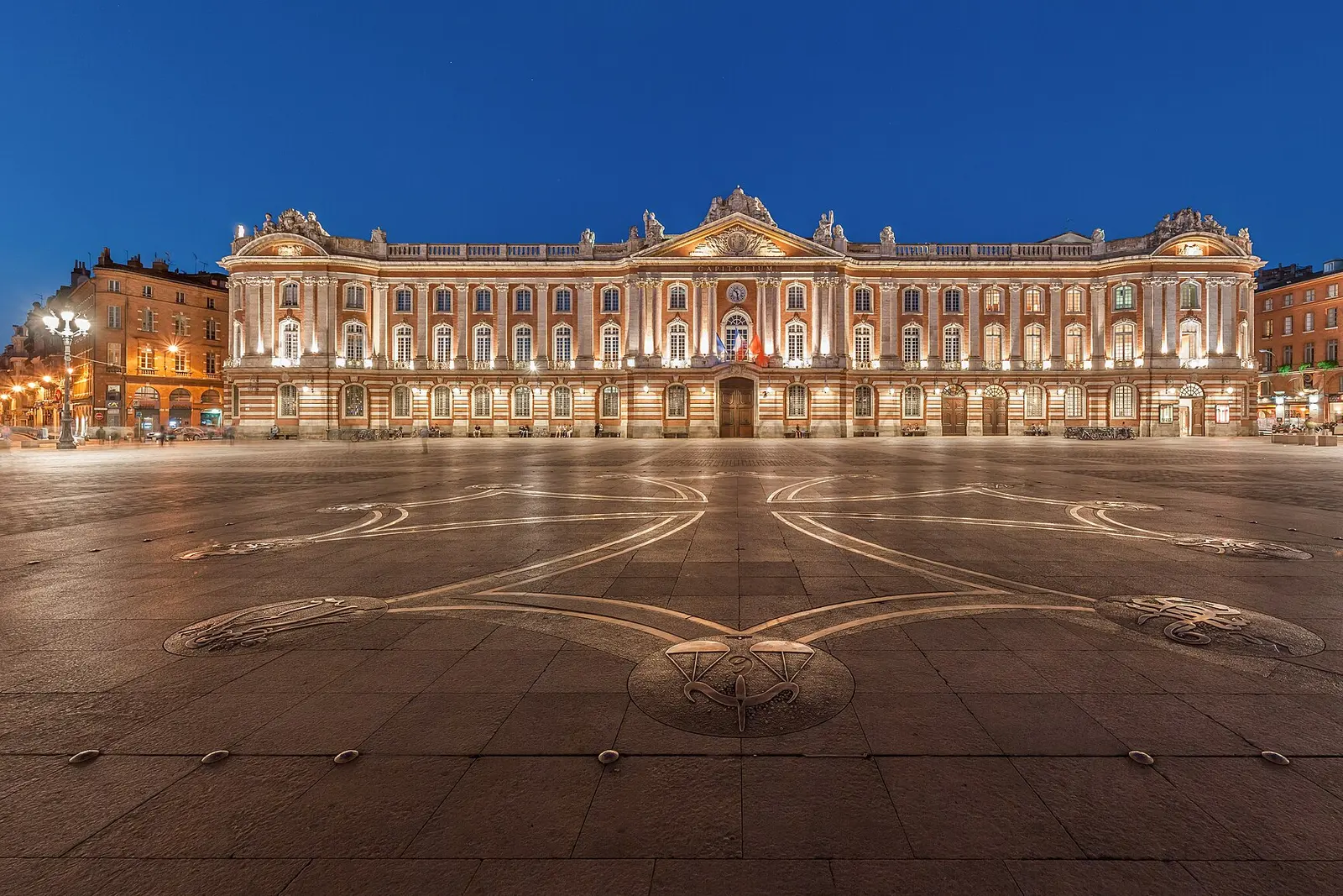 The Capitole square and its lit facade at night in Toulouse