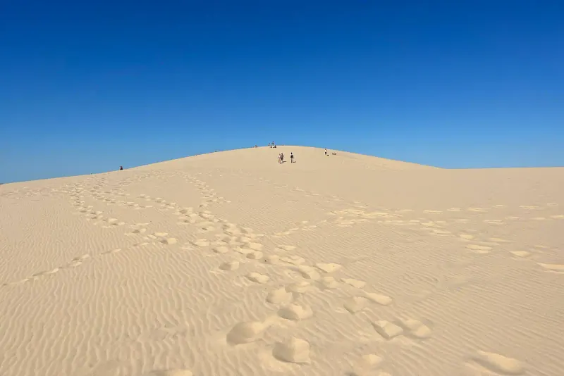 Visitors on the crest of the Dune du Pilat above the Atlantic