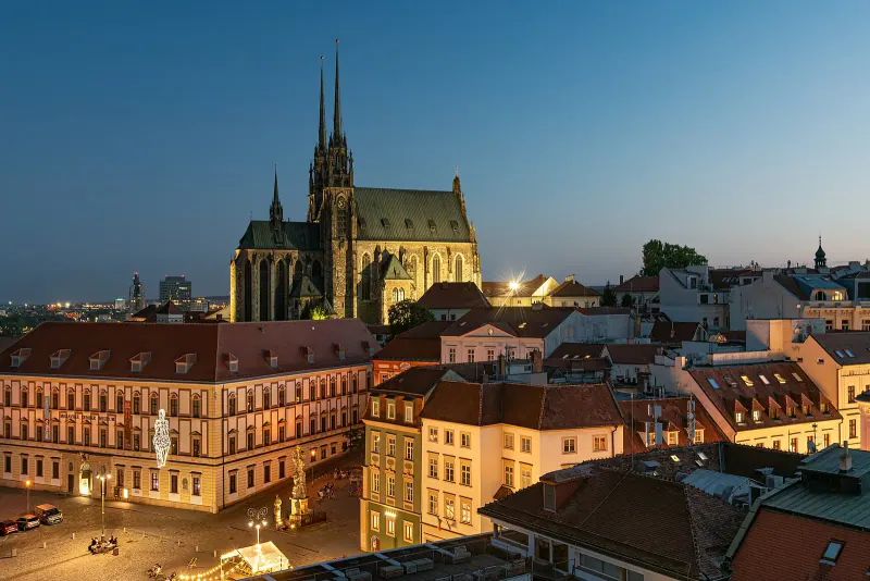Brno old town rooftops and cathedral lit at dusk