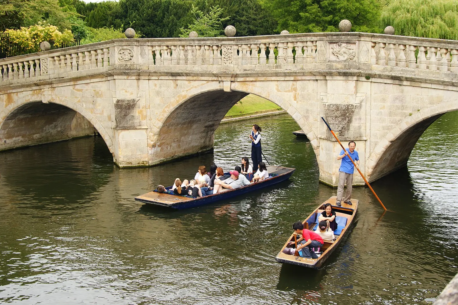 Punters passing under a bridge on the Backs