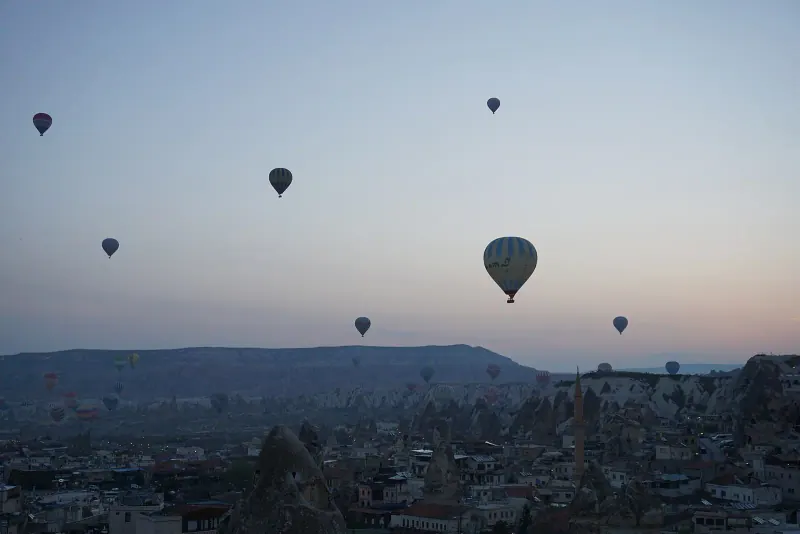 Balloons drifting over fairy chimneys, Cappadocia