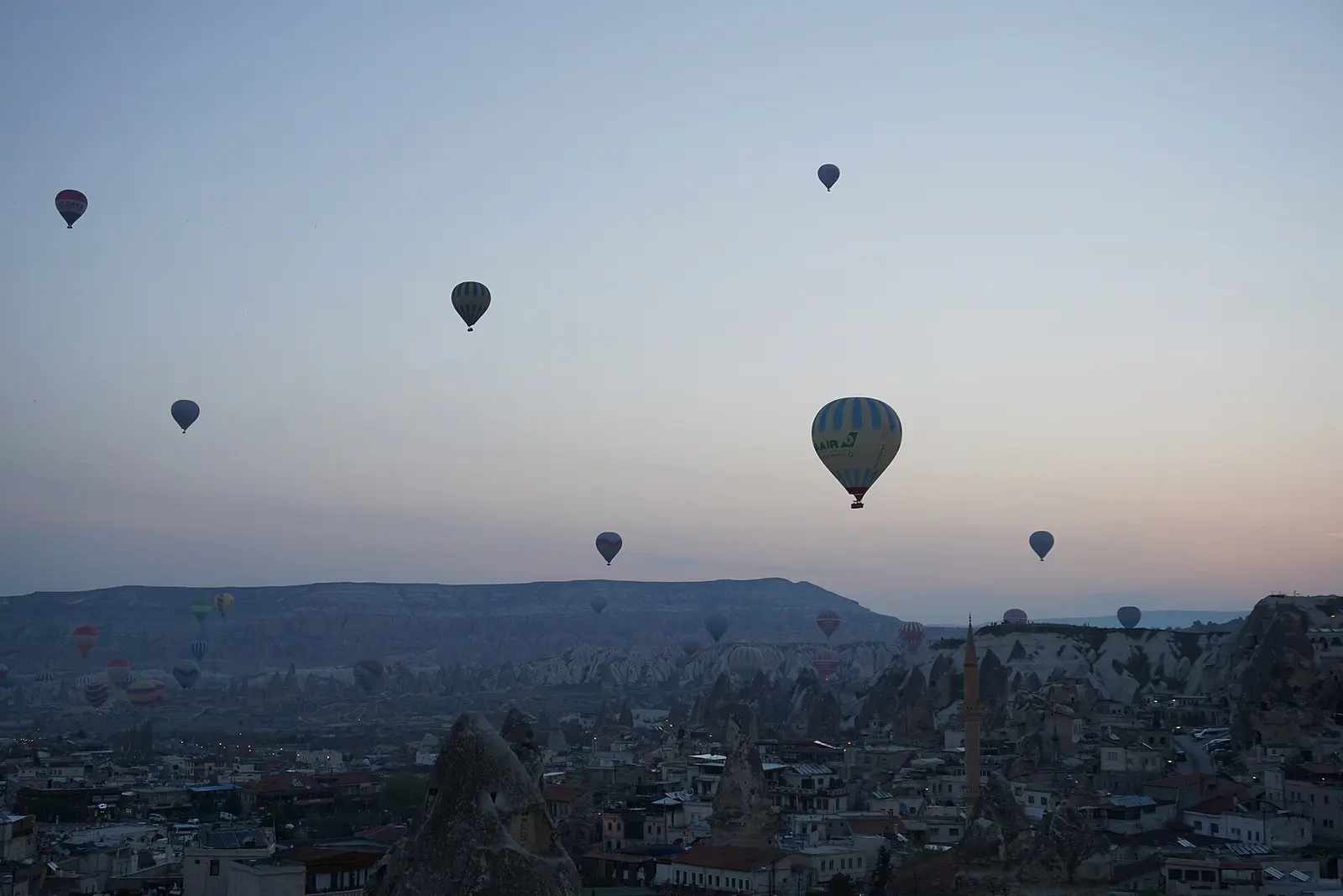 Balloons drifting over fairy chimneys, Cappadocia