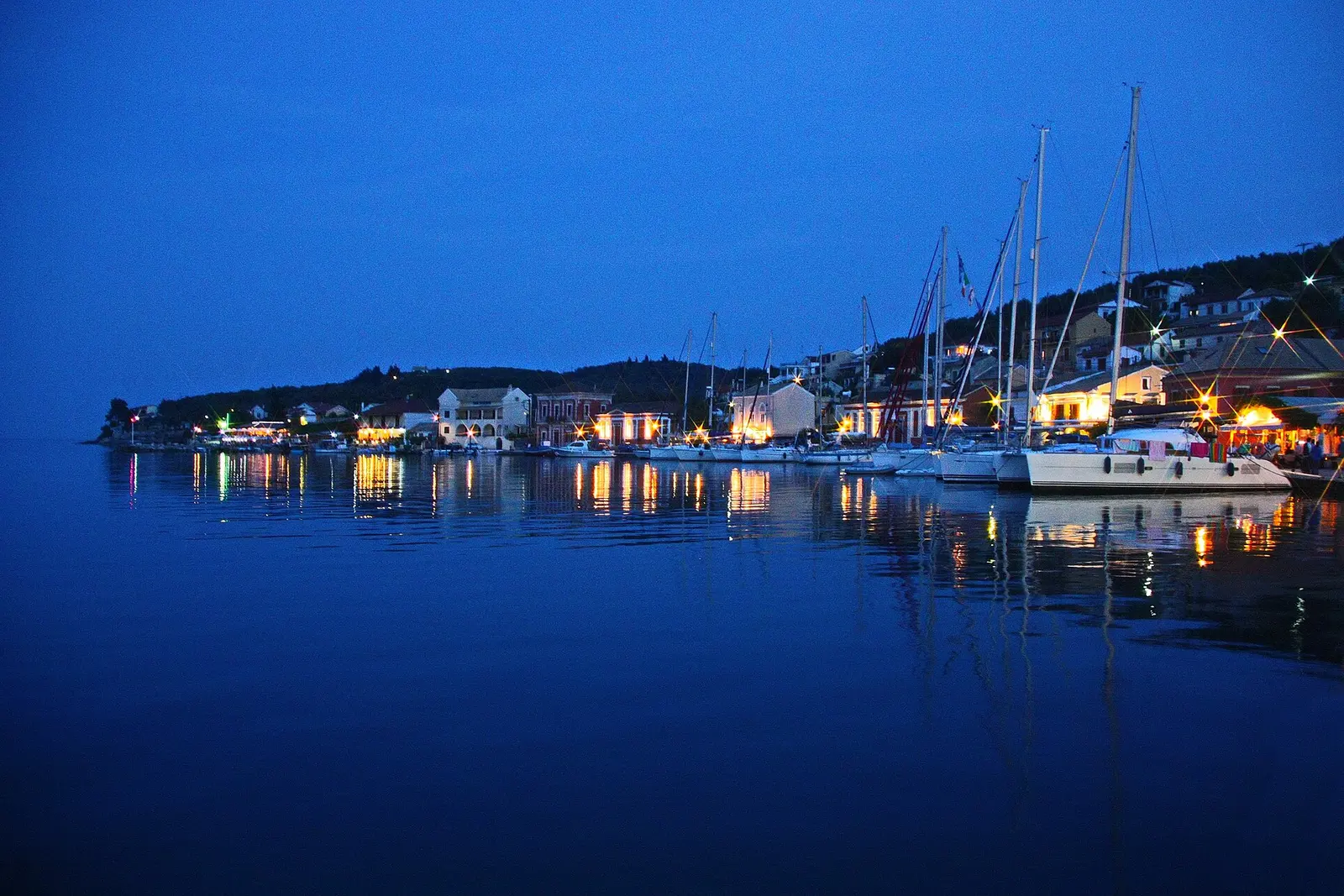 Boats anchored in an Antipaxos turquoise cove