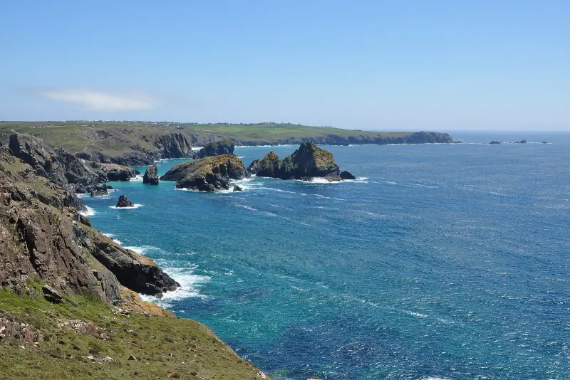 Rocky headlands and blue sea at Kynance Cove looking towards Lizard Point
