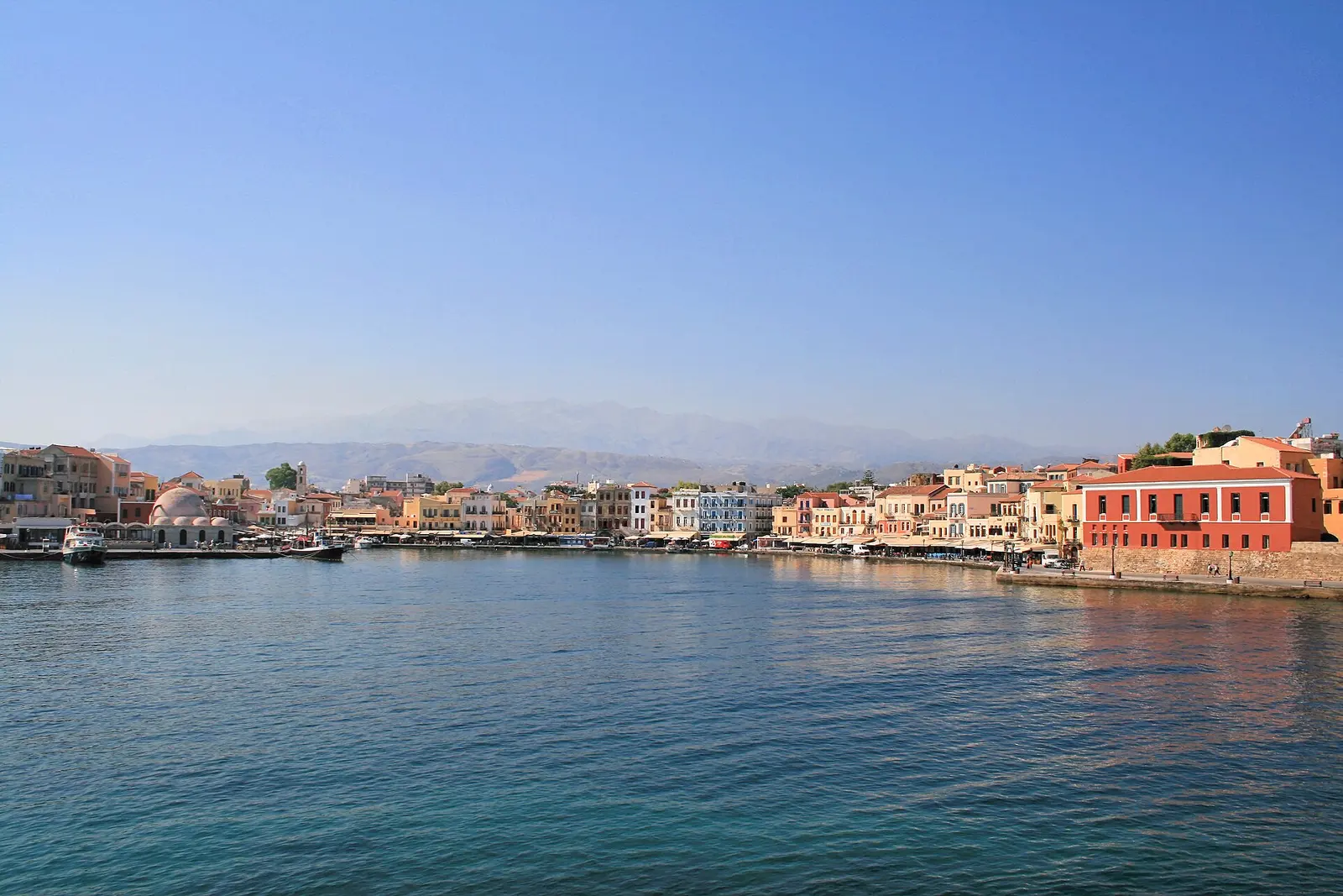 Chania's Venetian harbour curving toward its lighthouse, Crete