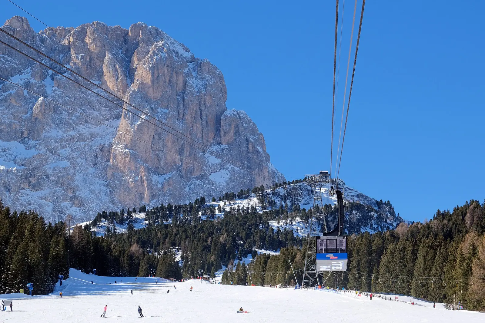 A gondola lift in front of Dolomite peaks on the Sellaronda