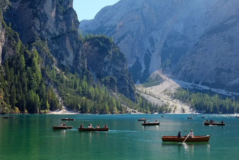 Rowing boats on the green water of Lago di Braies
