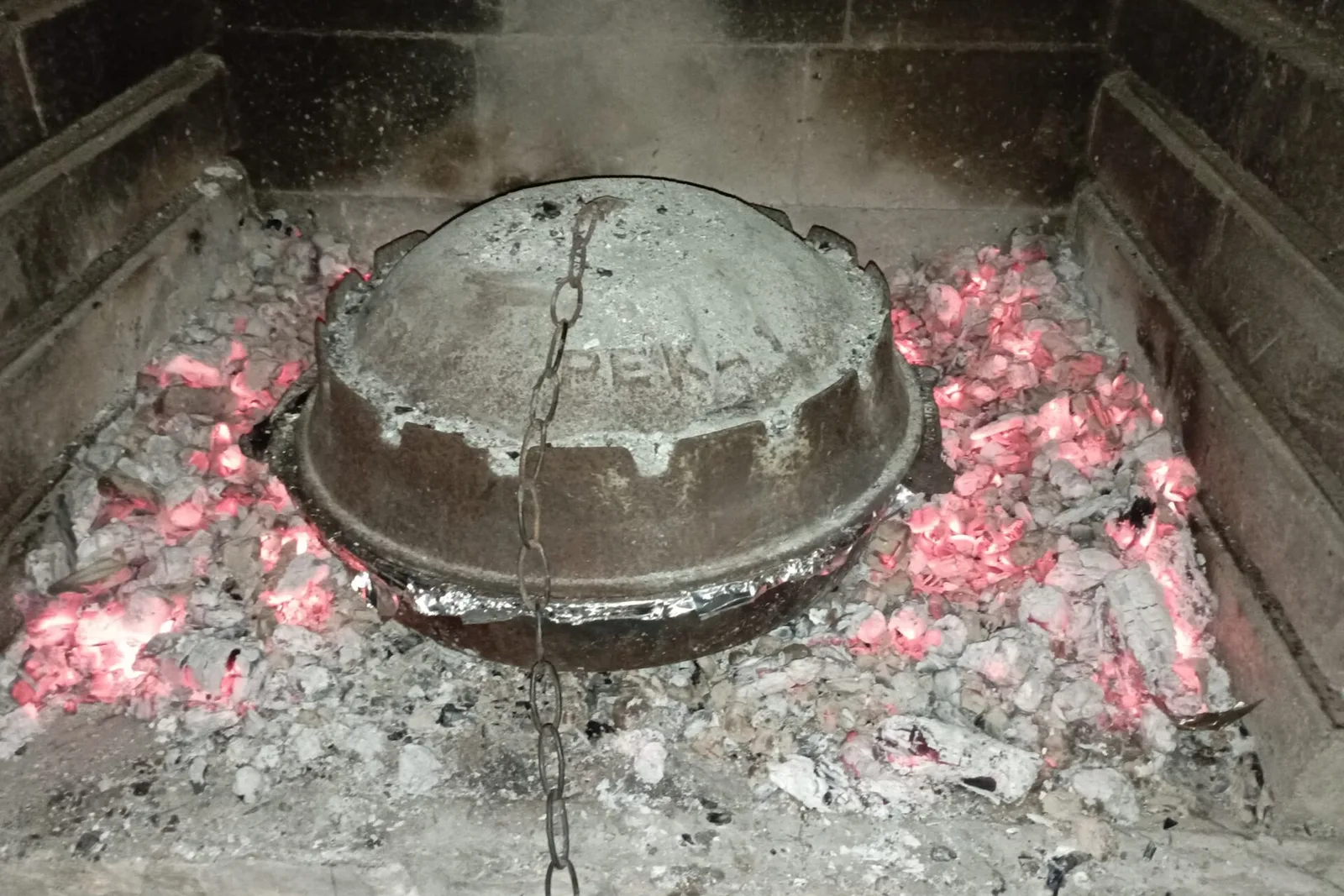 Peka dish cooked under a metal bell, a Dalmatian specialty