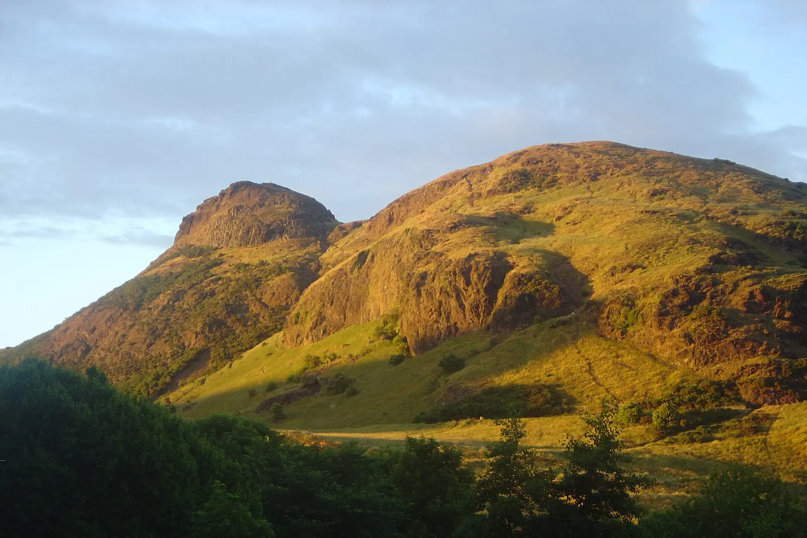 Arthur's Seat hill in Holyrood Park lit by evening sun