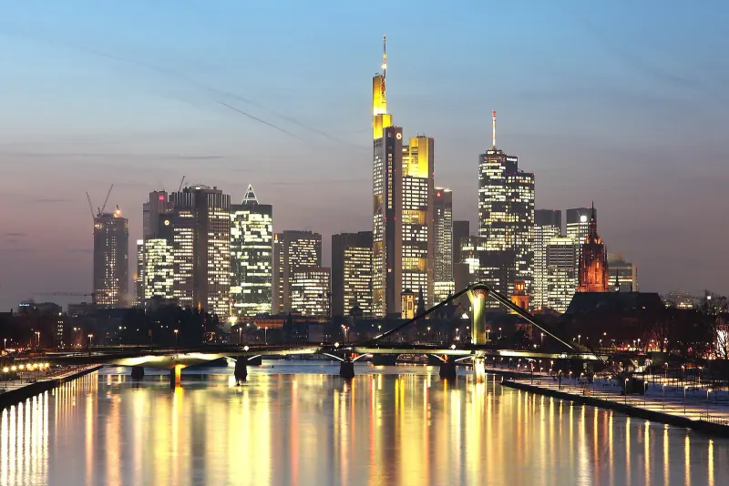 Frankfurt's skyline at dusk across the Main river