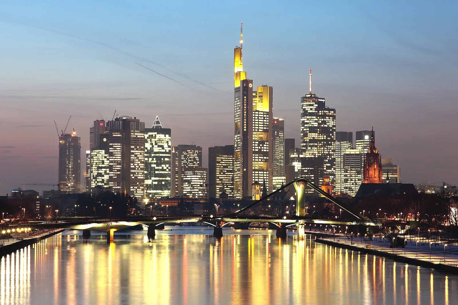 Frankfurt's skyline at dusk across the Main river