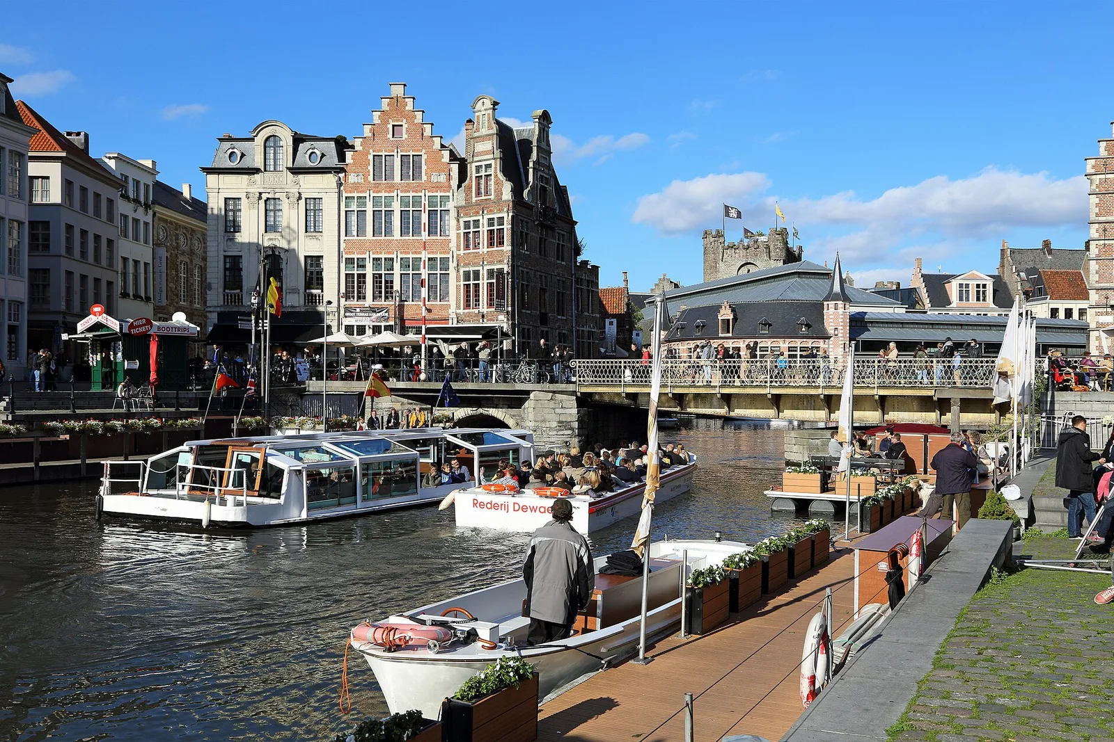 Tour boats moored on the Leie by the Grasbrug in Ghent