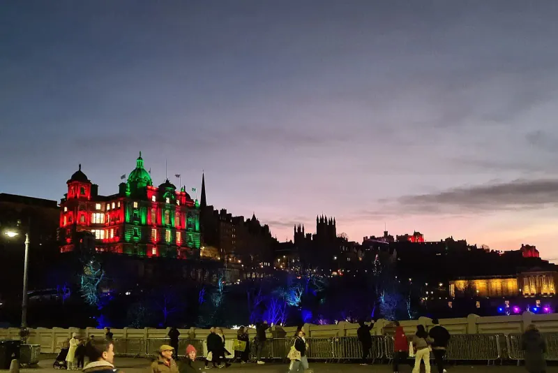 The Edinburgh skyline at dusk with the castle lit in colour