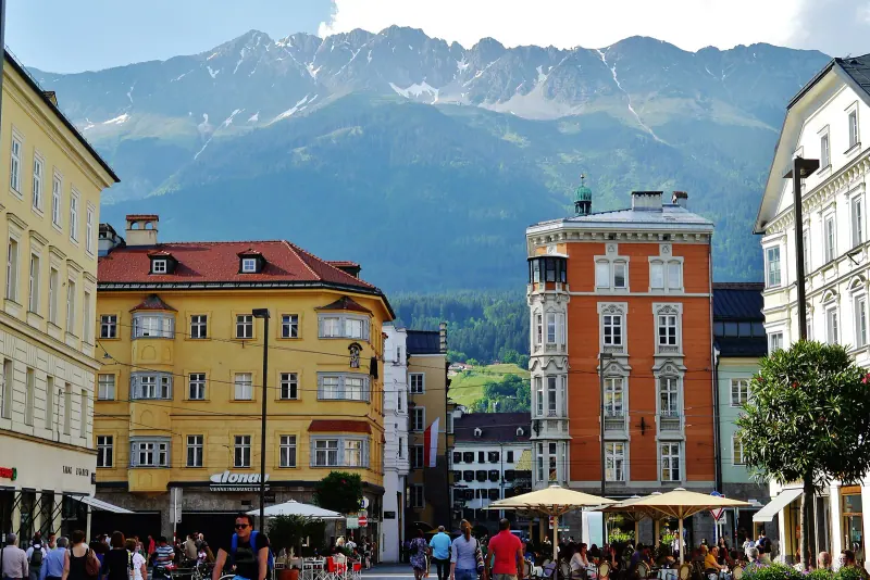 A street in Innsbruck's old town with mountains behind the rooftops