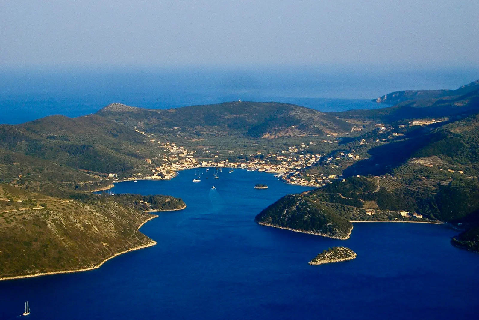 The harbour town of Vathy wrapped around its bay on Ithaca