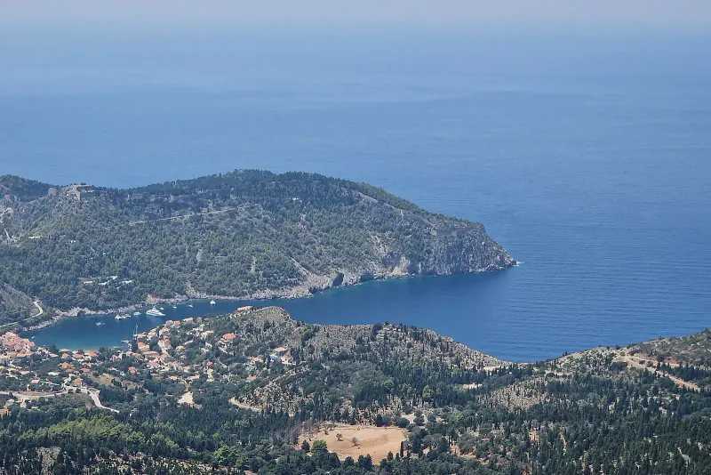 The village of Assos climbing its cypress-covered peninsula
