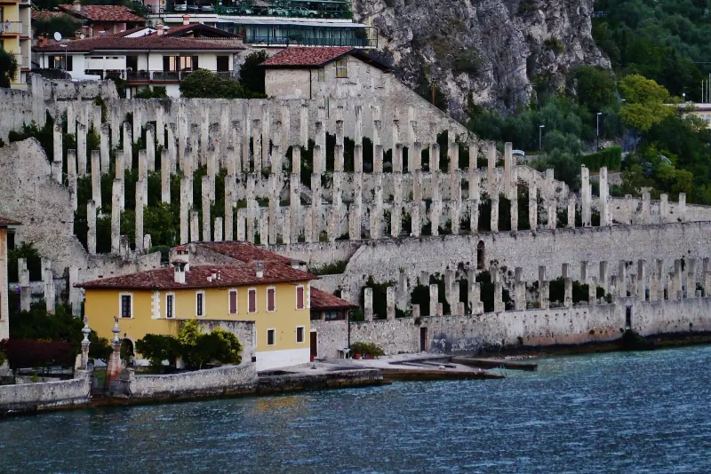 Limone sul Garda terraced lemon house walls rising above the water with a yellow villa at the shore