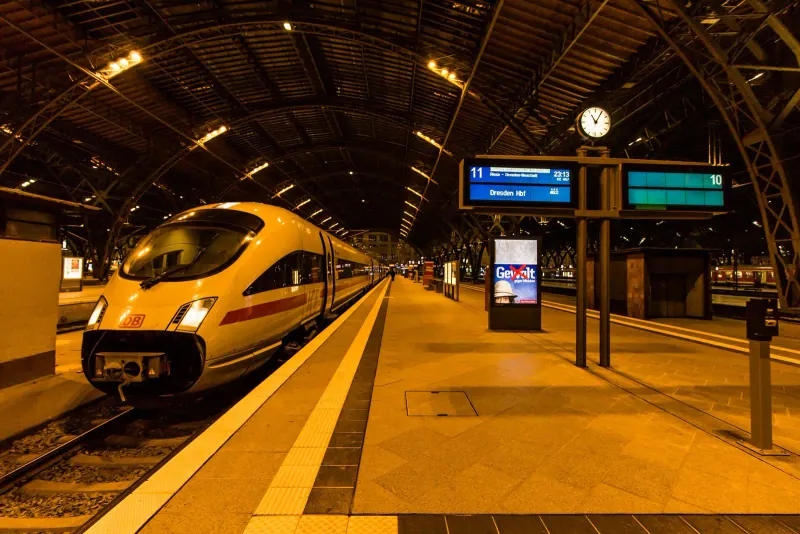 ICE train inside Leipzig Hauptbahnhof trainshed at dusk