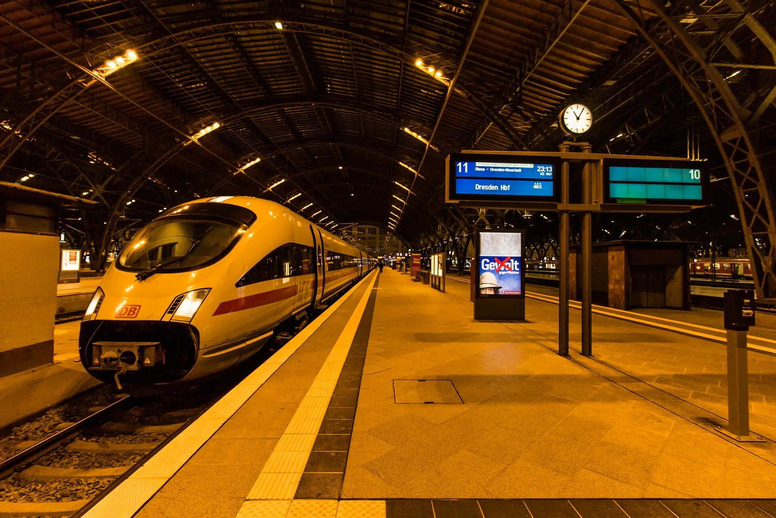 ICE train inside Leipzig Hauptbahnhof trainshed at dusk