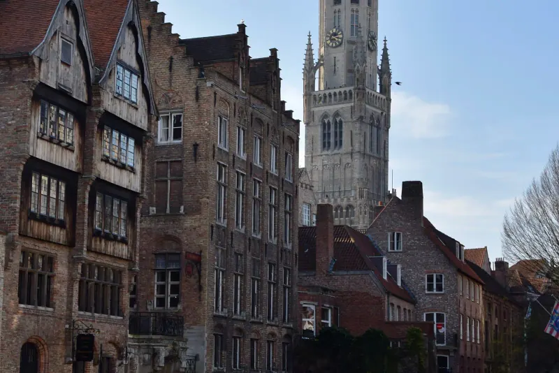 The Rozenhoedkaai canal view in Bruges with the Belfry tower