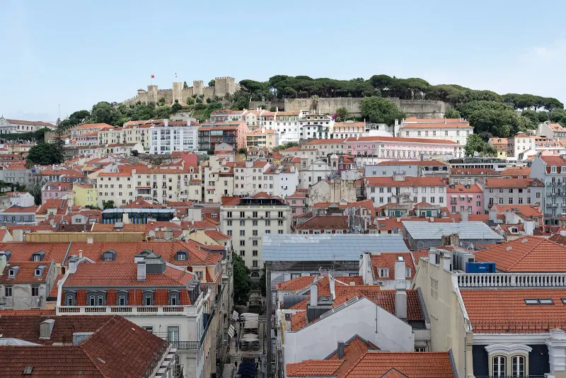 Lisbon's tiled rooftops with the castle on the skyline