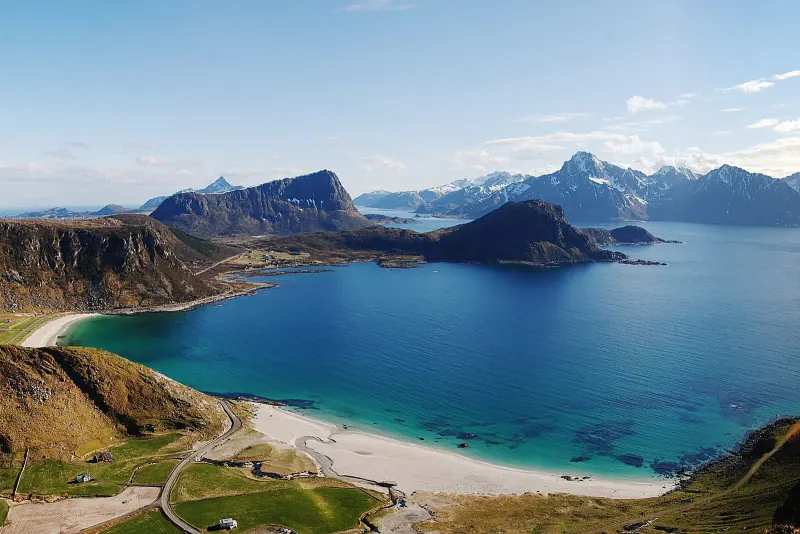 Haukland beach with white sand and turquoise water, ringed by mountains on Vestvågøy