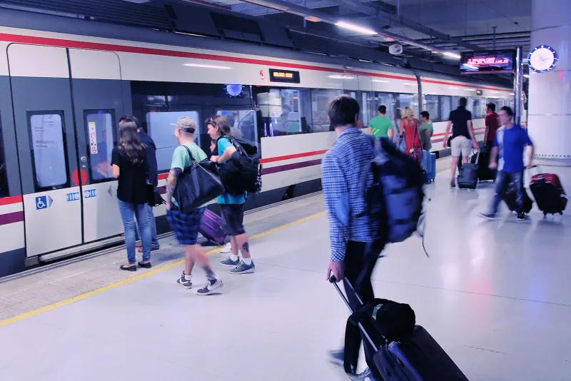 Passengers boarding a Cercanias train at Malaga Airport station