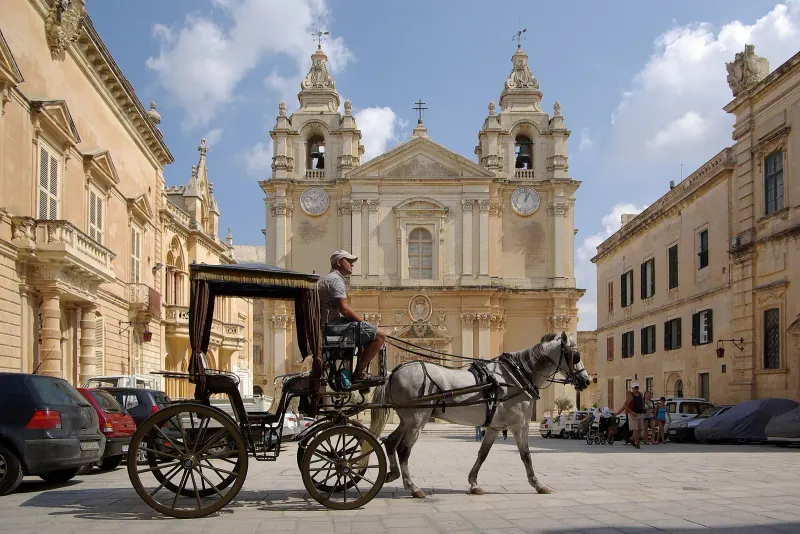A horse-drawn carriage on the square beside Mdina cathedral