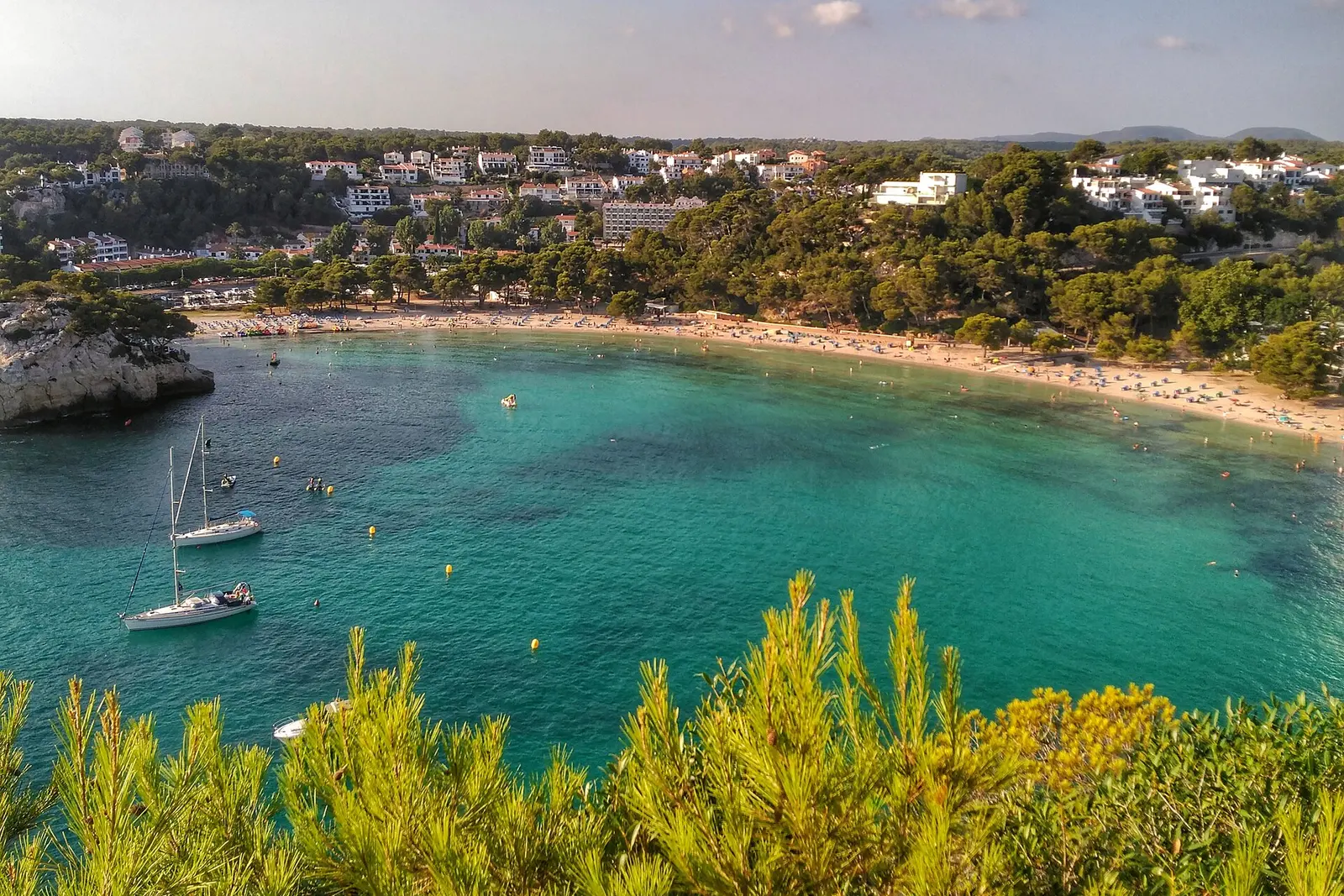 The white-sand cove of Cala Galdana ringed by pine cliffs