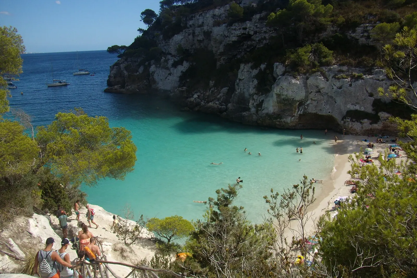 Turquoise water filling the tiny cove of Cala Macarelleta