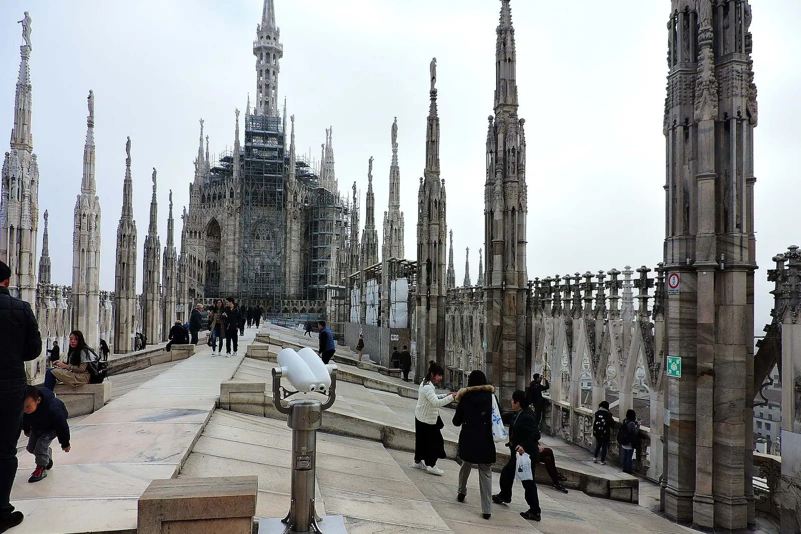 Visitors walking among the spires on the roof terraces of Milan Cathedral