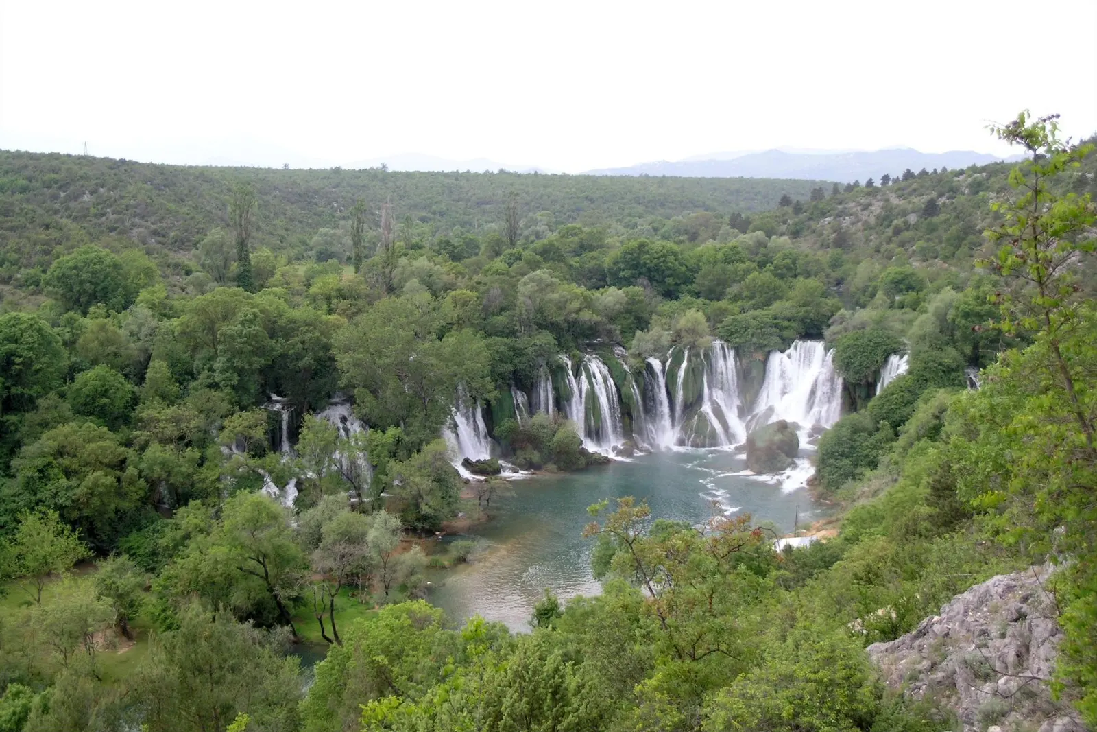 Waterfalls pouring into the pool at Kravice