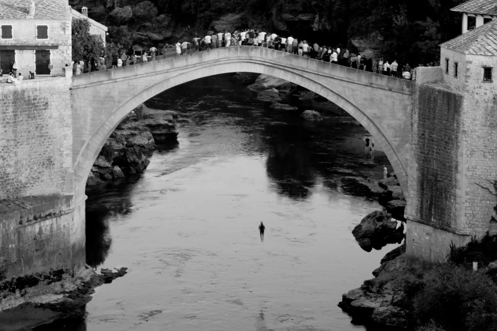 A diver mid-air beneath the Stari Most in Mostar
