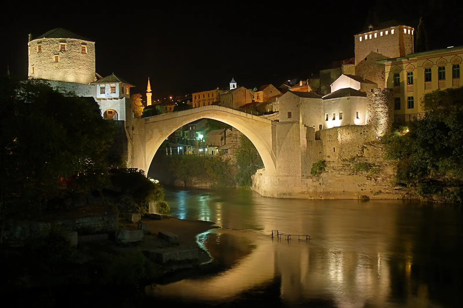 The Stari Most lit over the Neretva at night