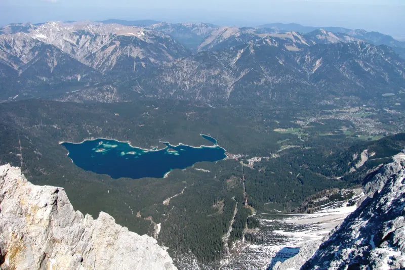 View from the Zugspitze summit down to the Eibsee lake and the Alps